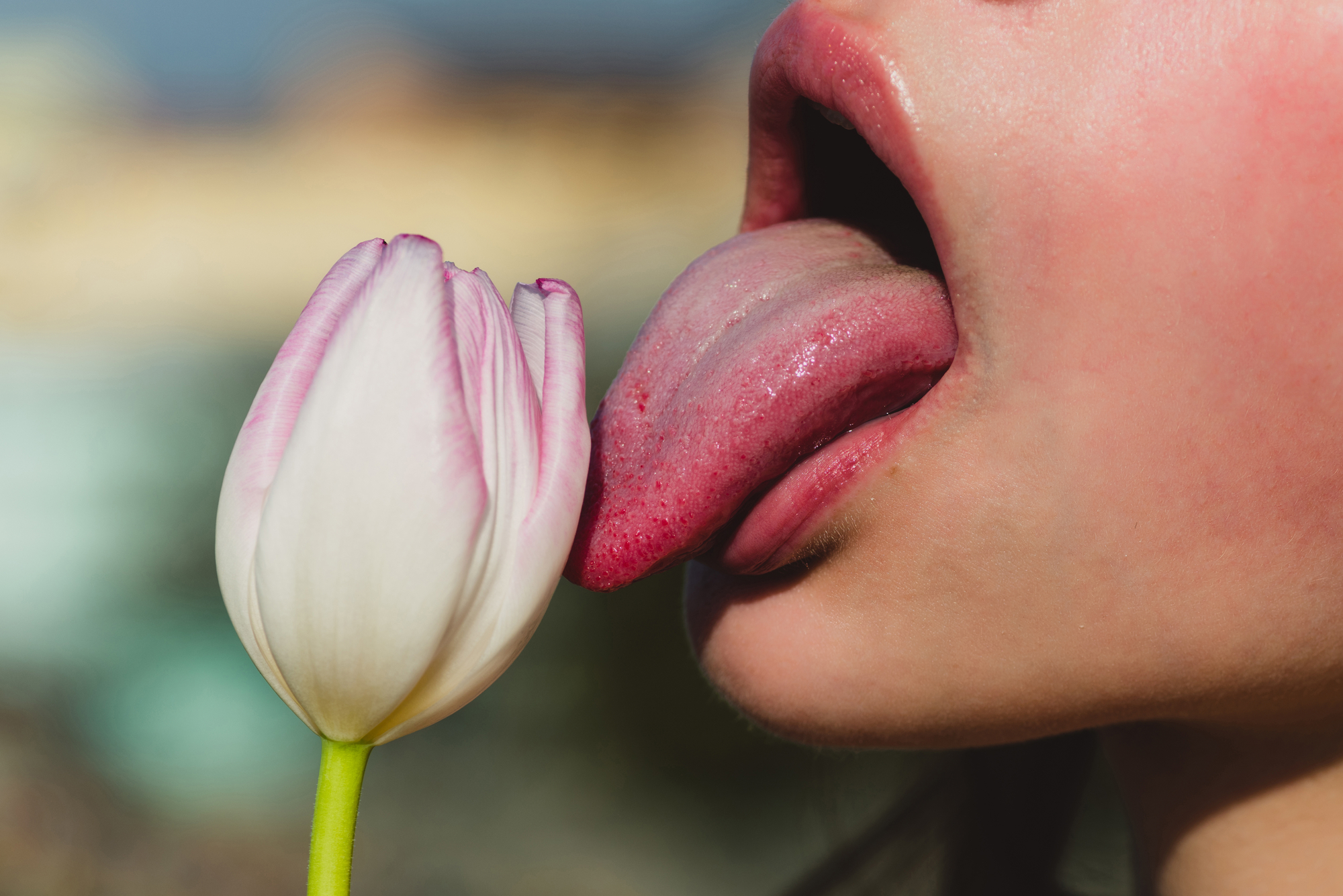 a woman making love to a flower